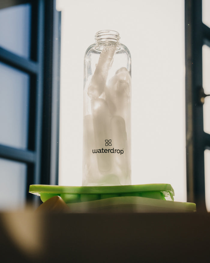 Glass bottle with six ice sticks from the Ice Tray, designed for perfectly chilled Microdrinks.