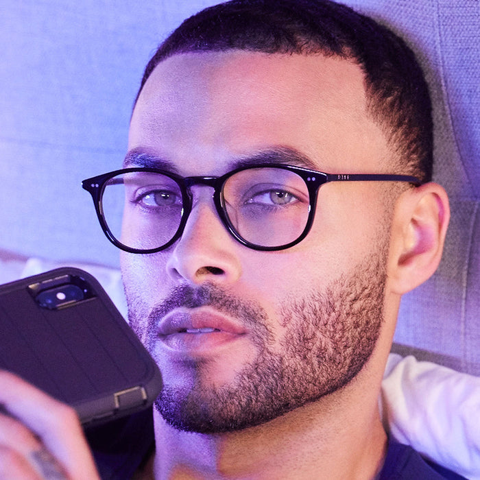 lifestyle - male model wearing jaxson black vintage crystal with blue light tech glasses.