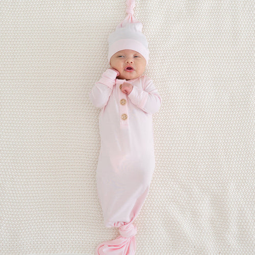 Newborn wearing Kyte Baby Knotted Gown with Hat Set in Sakura pink