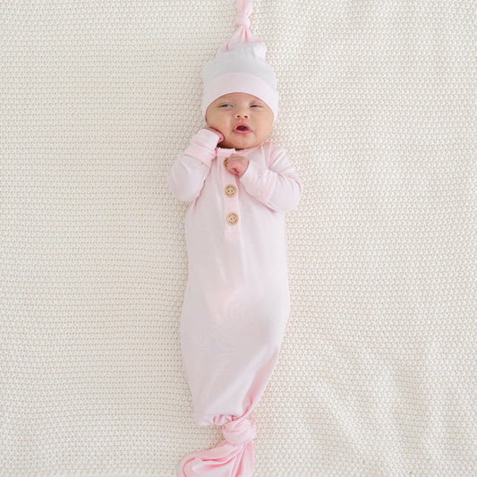 Newborn wearing Kyte Baby Knotted Gown with Hat Set in Sakura pink