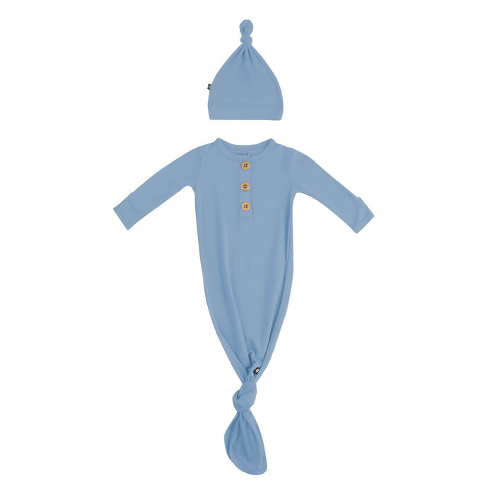 Flat lay of Kyte Baby Knotted Gown with Hat Set in Slate