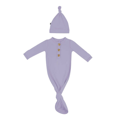 Flat lay of Kyte Baby Knotted Gown with Hat Set in Taro