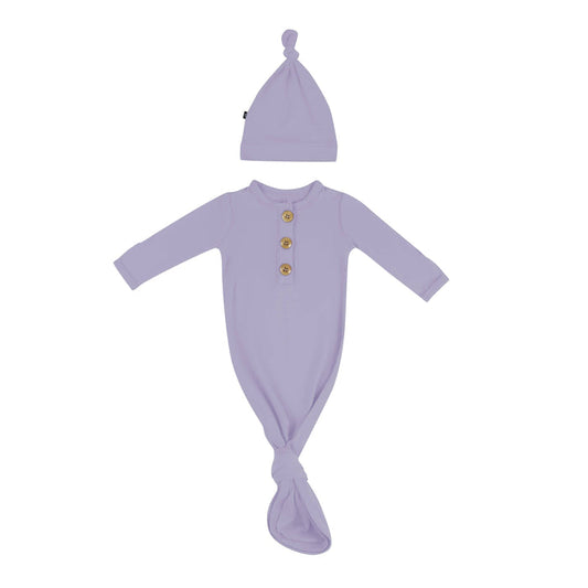 Flat lay of Kyte Baby Knotted Gown with Hat Set in Taro
