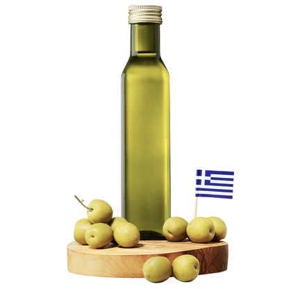 A bottle of extra virgin olive oil with a small Greek flag and fresh olives on a wooden board.