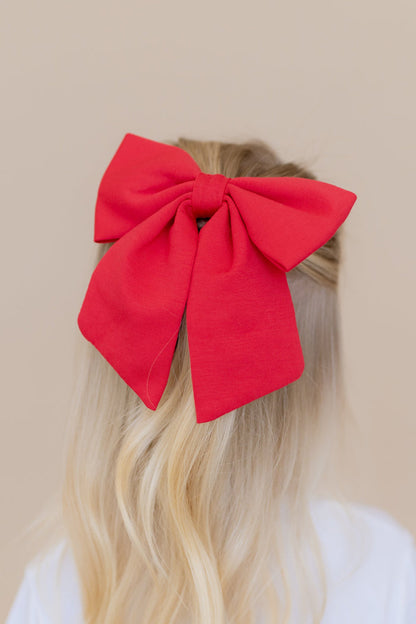 Large Alligator Clip Bow in Cardinal shown in young girls hair