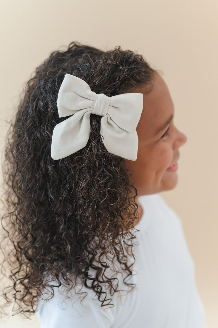 Close up of the Large Alligator Clip Bow in Oat shown in a young girls hair