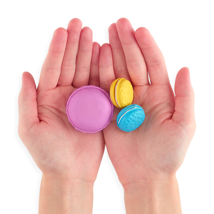 Three Le Macaron Patisserie Scented Erasers in persons hands