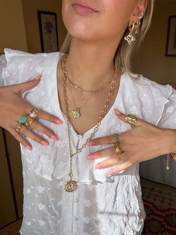 Gold jewellery stack styled for effortless layering