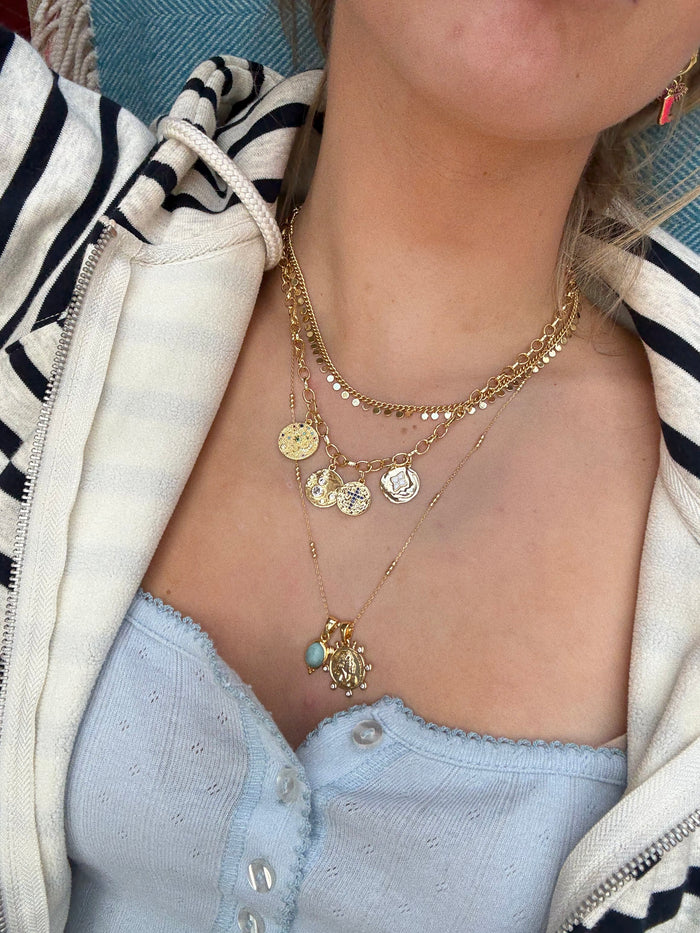 Gold jewellery stack styled for effortless layering