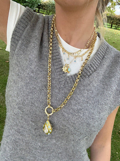 Cool jewellery stack with chunky gold necklaces