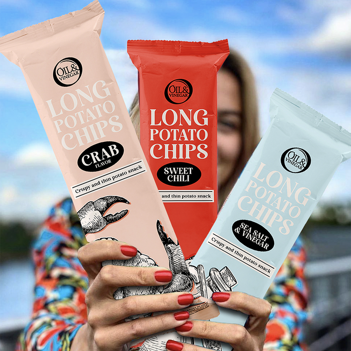 Woman holding three flavors of long potato chips in different colored packaging, Crab, Sweet Chili, and Sea Salt and Vinegar.