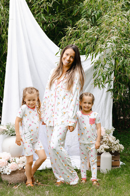Mom in long sleeve tulip printed pajamas with daughters in matching pjs