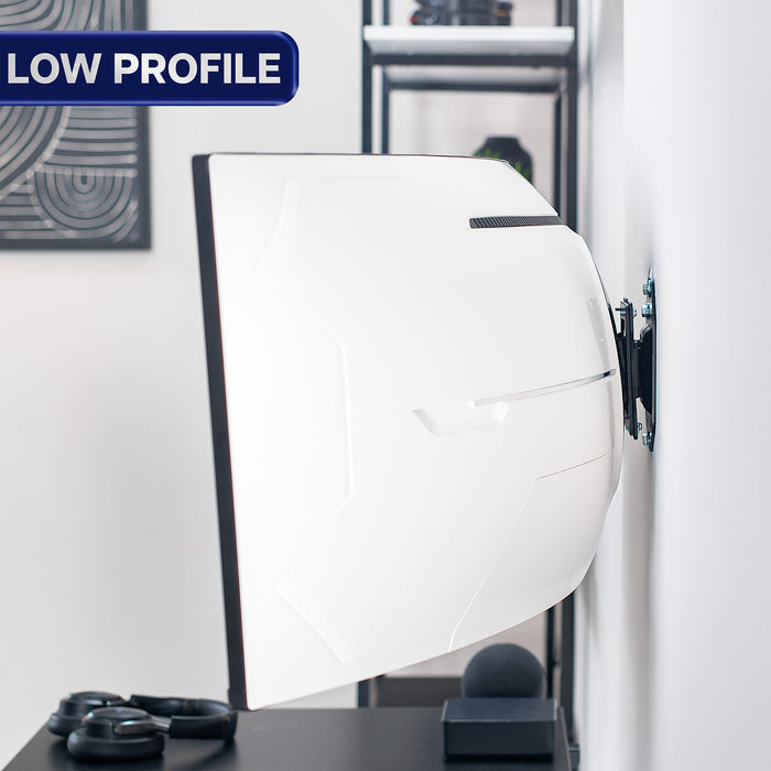 Ultrawide monitor mounted on wall with 'Low Profile' label on a desk in an office setting