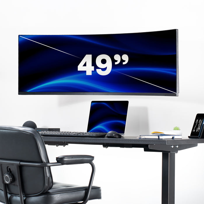 Large curved computer monitor displaying '49”' on a desk setup with a chair.