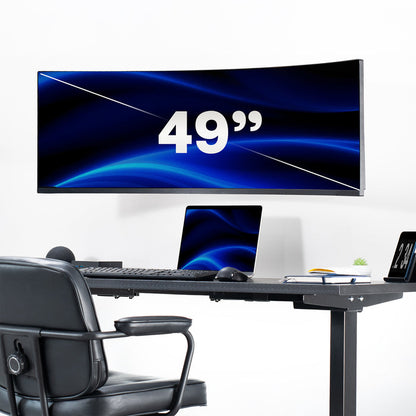 Large curved computer monitor displaying '49”' on a desk setup with a chair.