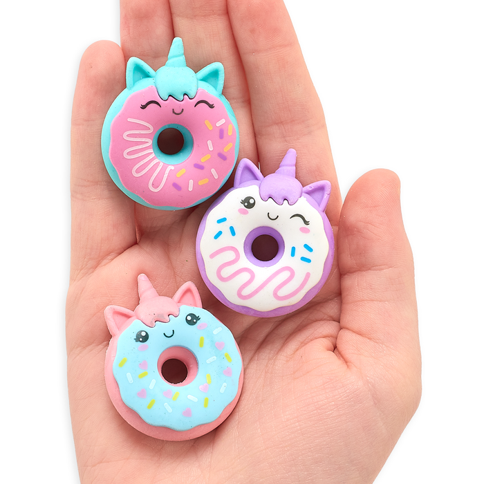 Hand holding all three Magic Bakery Unicorn Donut Erasers in its palm
