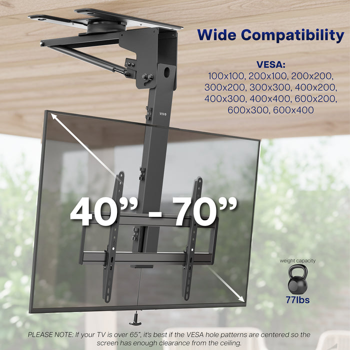 Manual Flip Down TV Ceiling Mount with compatibility details on a wooden surface