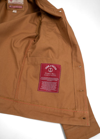 Brown jacket interior with red "Iron and Resin" label, highlighting "Freedom Riders" design, crafted in California.