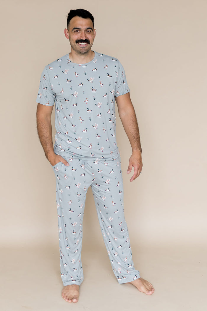 Smiling male modeling the Men's Crew Neck Tee in Mallard Duck with the hand in the pocket of the Men's Lounge Pant in Mallard Duck