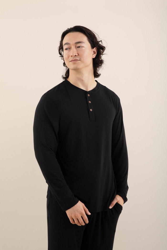 Male model wearing the Men's Long Sleeve Henley Top in Midnight and matching lounge pants