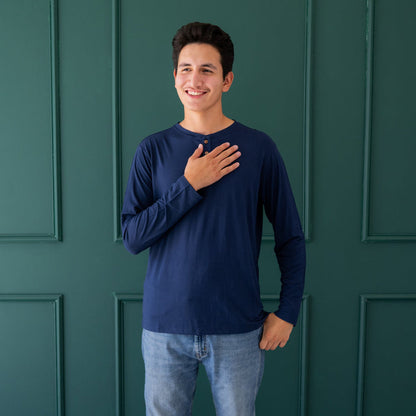 Man wearing Kyte Baby Long Sleeve Henley Top with wood buttons in Navy blue