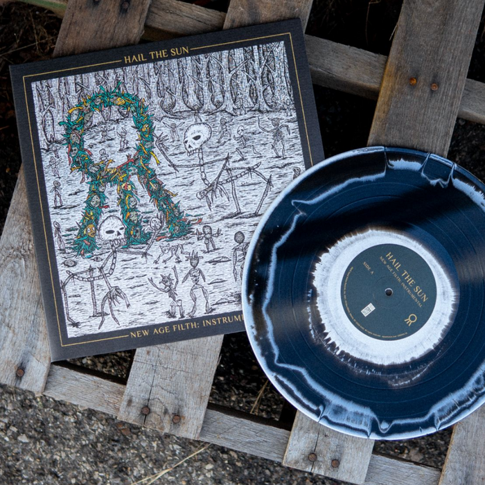 A black and white vinyl record by Hail The Sun rests on a wooden pallet beside its cover, which shows skeletons, trees, and a wreath design. The cover reads: Hail The Sun - New Age Filth instrumental.