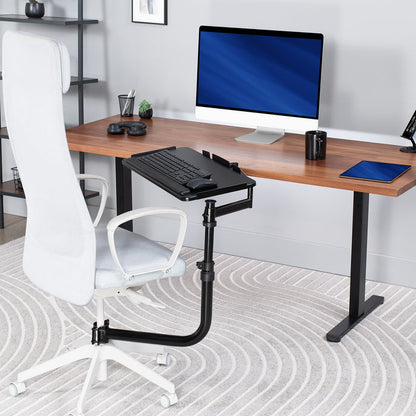 Walnut wood desktop on black desk frame with an adjustable office chair mounted premium keyboard tray on desk chair.