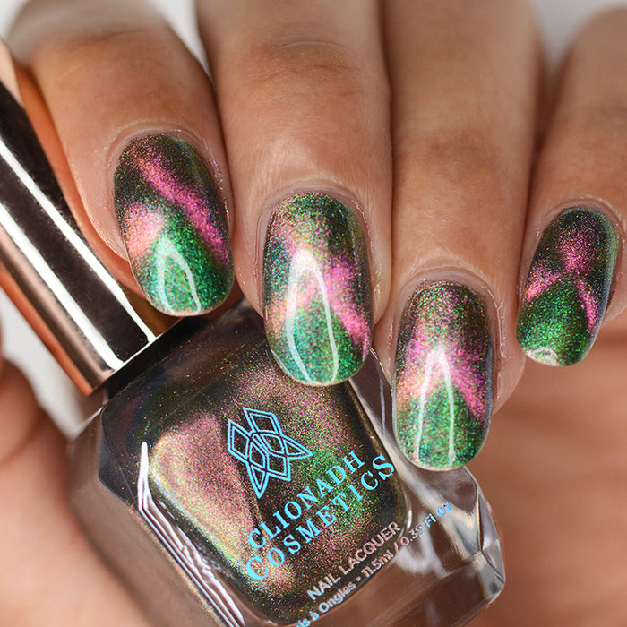 Close up of nails done with Psilocybin Nail Lacquer featuring a design to show off the magnetic effect on medium skin tone.