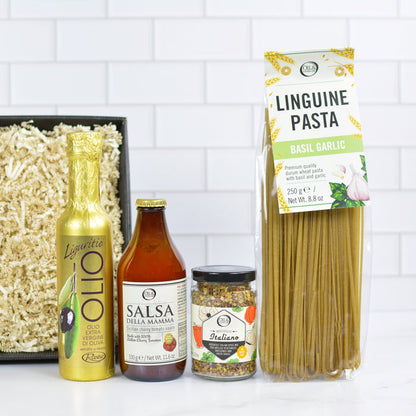 Packaging of linguine pasta and Italian ingredients on a white surface with a tiled wall background
