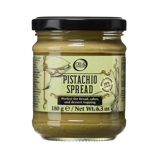 A glass jar of Pistachio Spread with a green label, indicating that it is perfect for bread, cakes, and dessert toppings.
