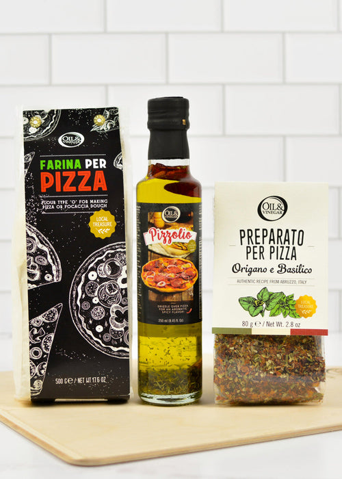 Three pizza ingredients on a wooden board with a white tiled wall background
