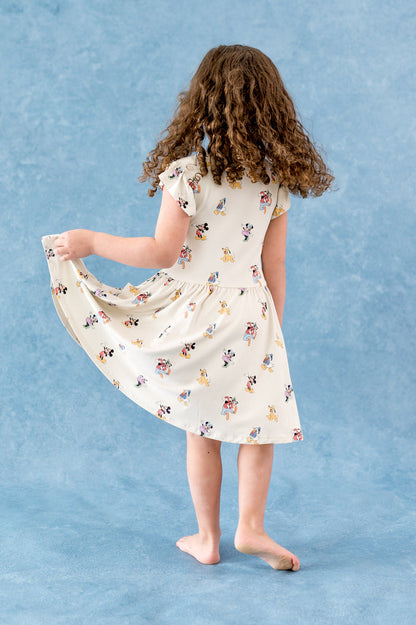 Mickey and friends patterned dress against a blue background