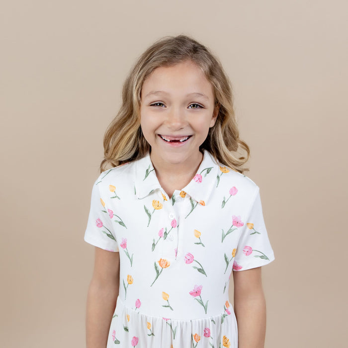Close up a young girl wearing the Polo Dress in Tulip