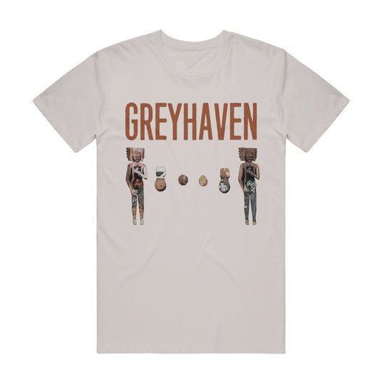 Sand colored short sleeve t-shirt with abstract graphics of characters with boxes and strange colors on them.  Above the characters is text that reads GREYHAVEN.