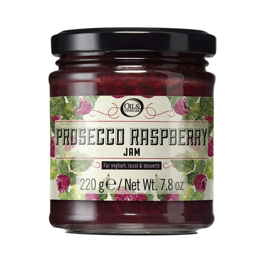 jar of prosecco raspberry jam with a label with raspberries and leaves drawings as decor with the product name and size of 7.8 ounces
