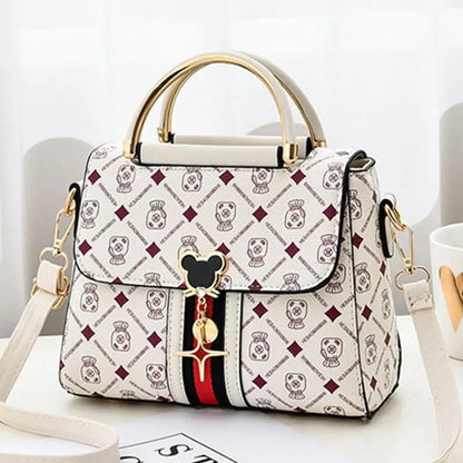Designer handbag with brand logo on a white surface