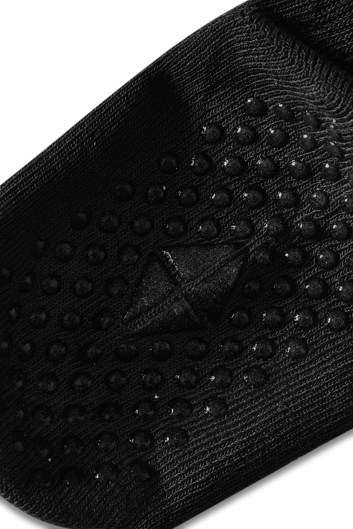 Angled bottom of sock with grips.