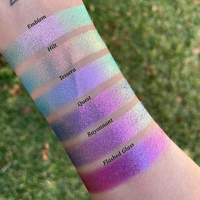 Top angled arm swatches on fair skin tone of Rayonnant Electric Multichrome Eyeshadow shifts compared to Emblem, Hilt, Tessera, Quest and Flashed Glass