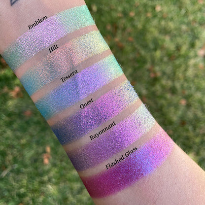 Top angled arm swatches on fair skin tone of Rayonnant Electric Multichrome Eyeshadow shifts compared to Emblem, Hilt, Tessera, Quest and Flashed Glass