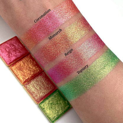 Top angled arm swatches on fair skin tone of Reign Vibrant Multichrome Eyeshadow shifts compared to Coronation, Monarch and Topiary