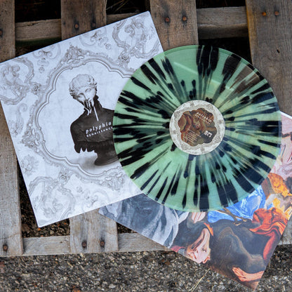 Square vinyl with a white background that depicts elegant architectural engravings. There is a shoulders up statue of a woman in the center of the vinyl. There is text on the chest of the woman statue that says POLYPHIA and below that text RENAISSANCE. Layed on top of the Vinyl cover is the vinyl itself which is colored black and light blue. Underneath both the vinyl cover and the vinyl is the vinyl insert that has abstract art on it and underneath that is a wood pallet.