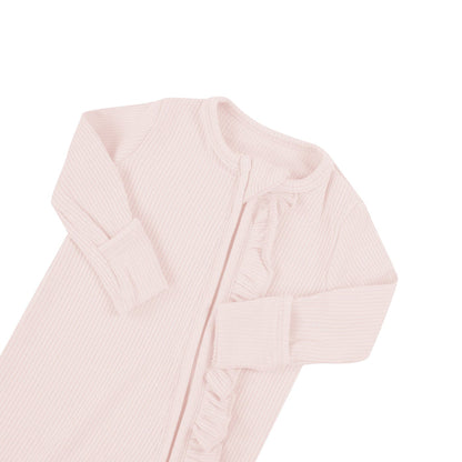 Fold-over cuffs on Kyte Baby Ribbed Ruffle Zippered Footie in Blush pink