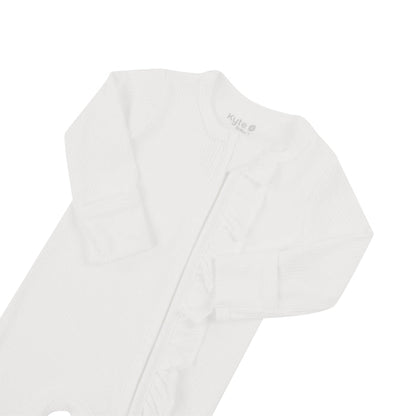 Flat lay displaying fold over cuffs on Kyte Baby Ribbed Ruffle Zipper Footie in Cloud