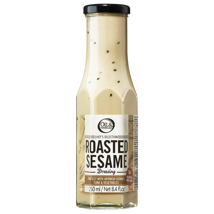 A bottle of Roasted Sesame Dressing with visible sesame seeds throughout the dressing.