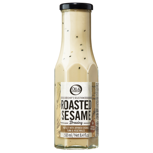A bottle of Roasted Sesame Dressing with visible sesame seeds throughout the dressing.