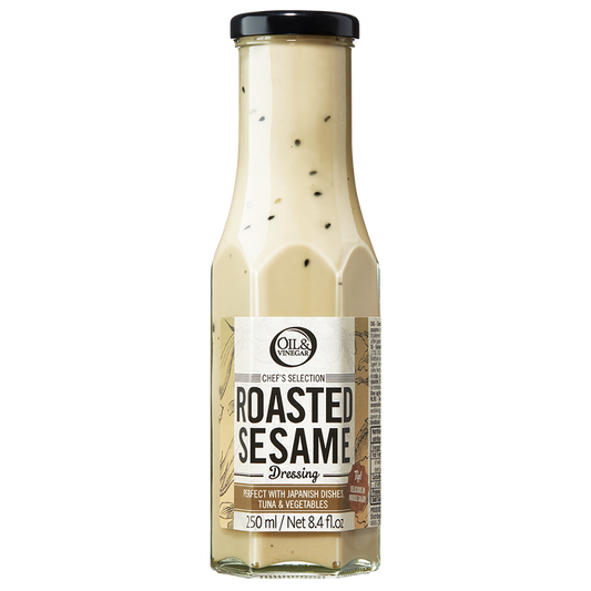 A bottle of Roasted Sesame Dressing with visible sesame seeds throughout the dressing.
