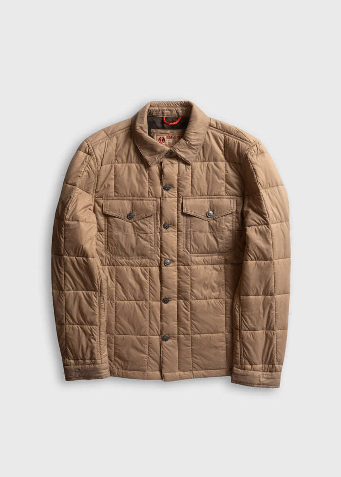 Tan quilted jacket with button closure and two chest pockets, displayed on a plain white background.