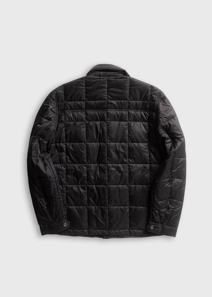 Black quilted jacket with buttoned cuffs, viewed from the back, showcasing its sleek design and textured fabric pattern.