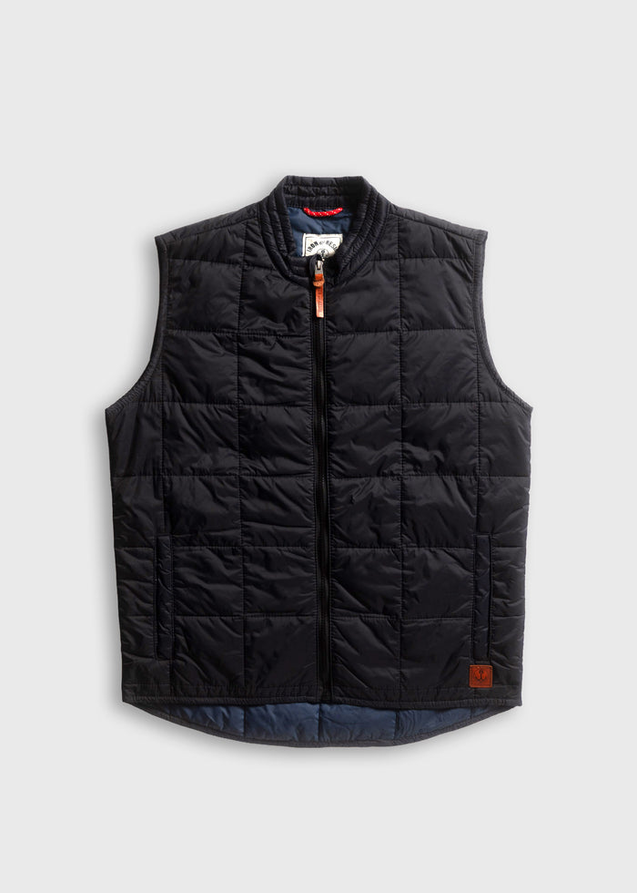 Black quilted vest with a front zipper and leather pull, displayed on a white background. Simple, stylish, and versatile design.