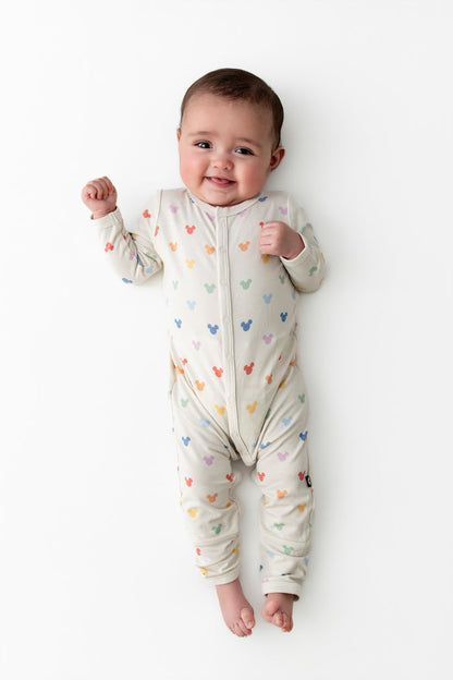 Baby wearing a snap romper in a mickey head pattern